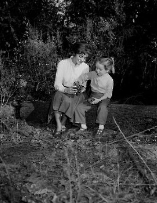 Girls observing pine cone Poster