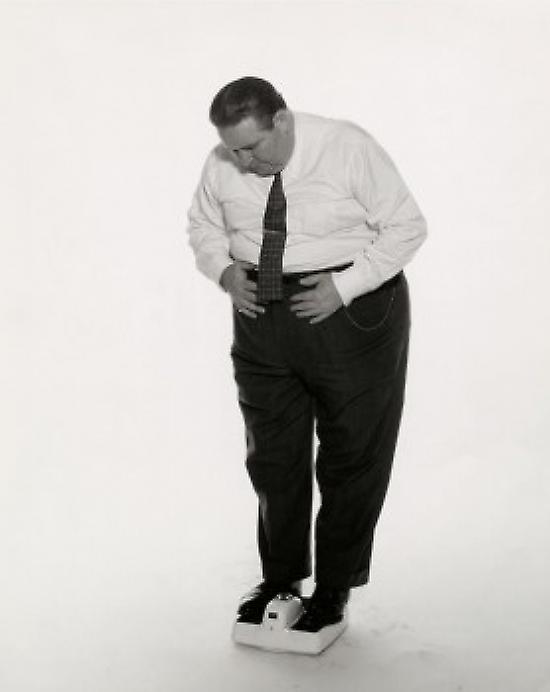 Obese man standing on a weight scale Poster