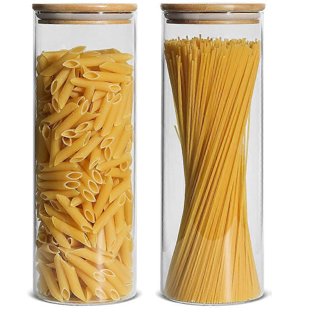 A set of 2 transparent glass spaghetti cans with covers for storing grain, pasta, noodles and flour
