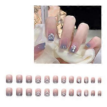 Ongles factices réutilisables, décorés de motifs de papillons et ayant un aspect brillant.
