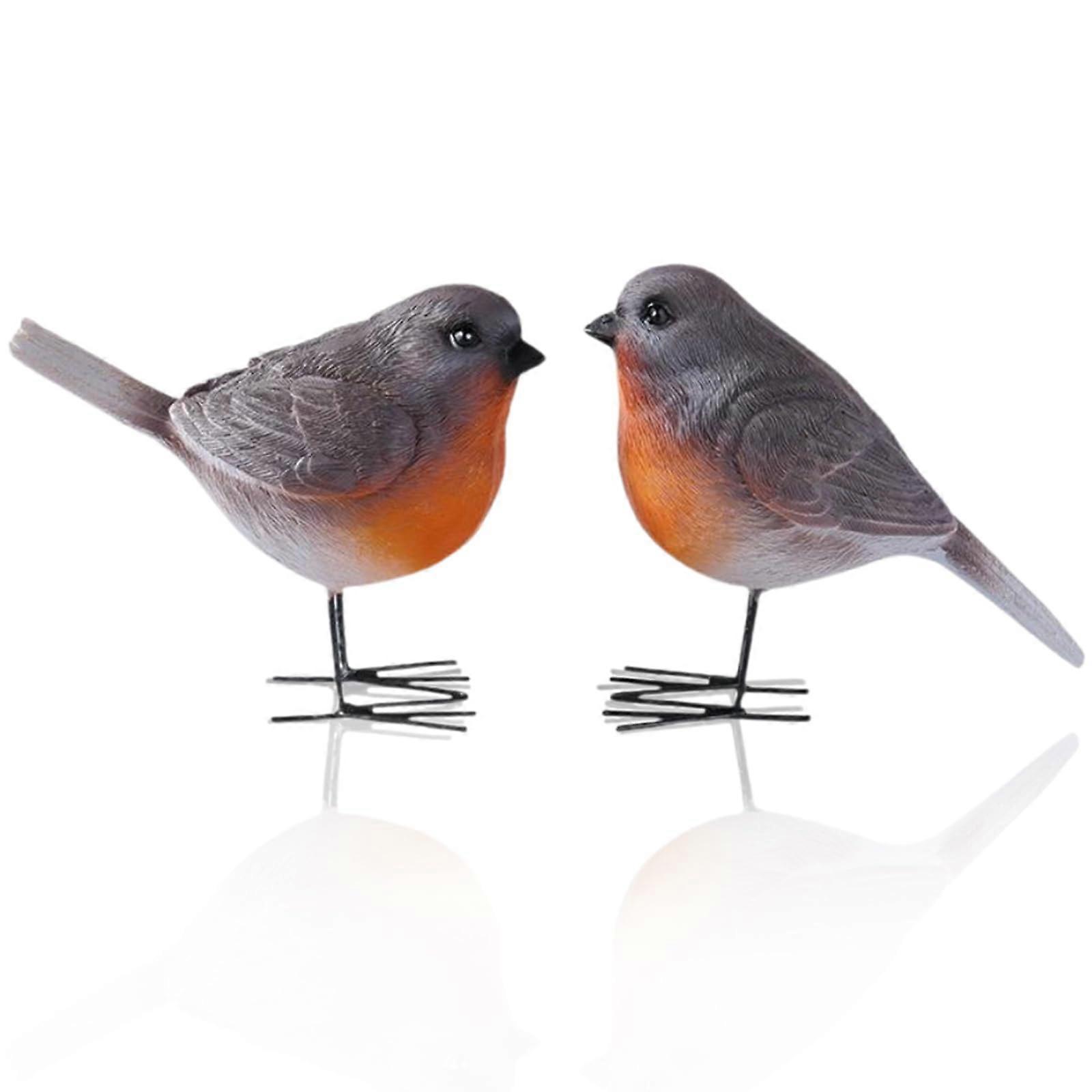 Two lifelike robin statues