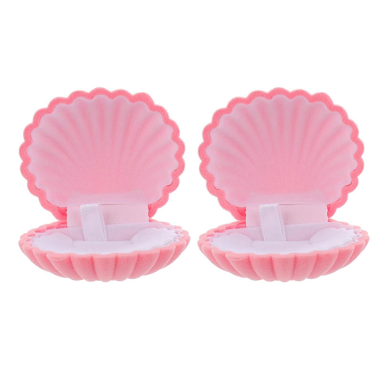 Here's a well structured and professional product description based on the title you provided:

 

**2pcs Creative Shell Shaped Jewelry Storage Box –