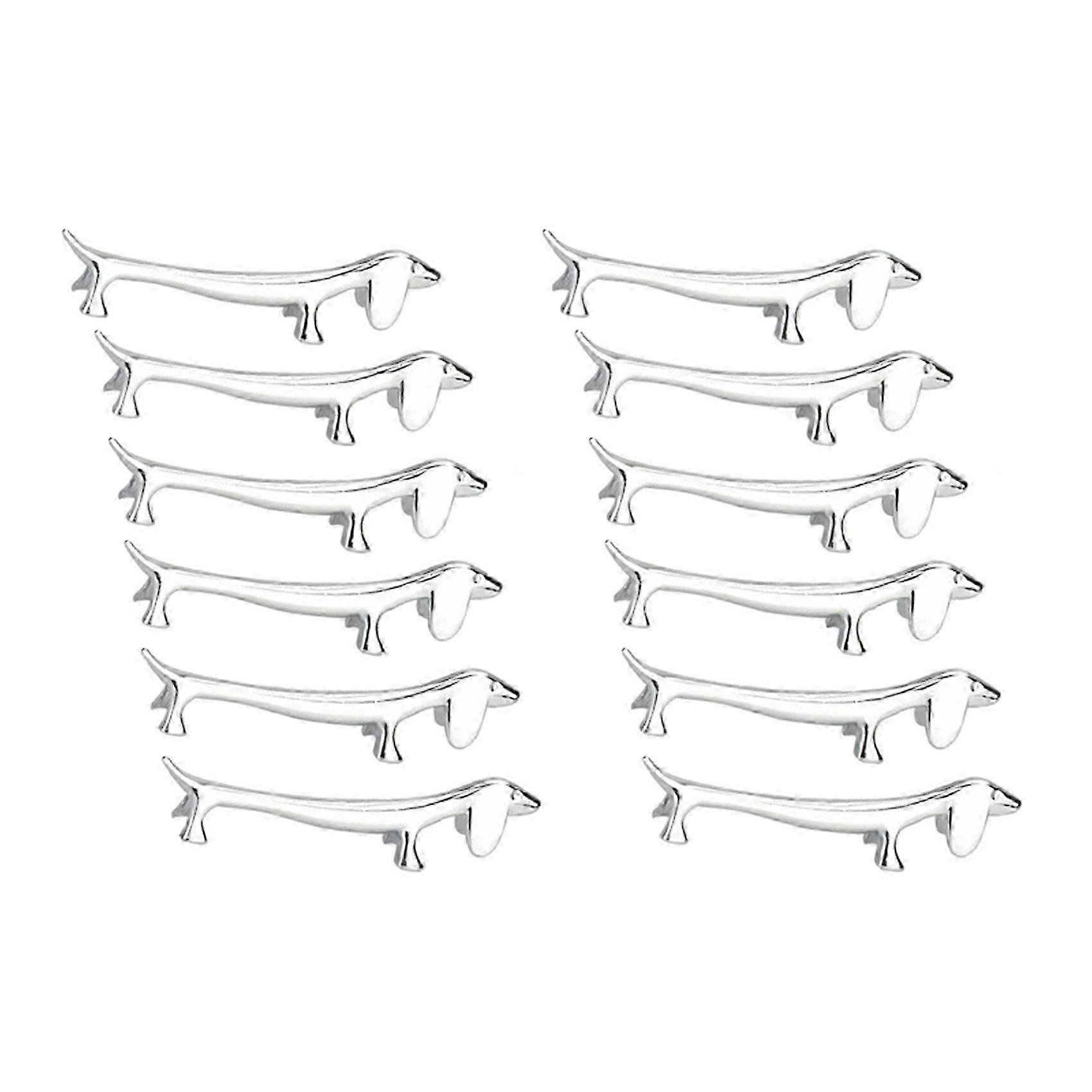 12 stk. spisepinner, liten hund, spisepinnerholder, dachs, sinklegering, gaffelstativ, skje, servise