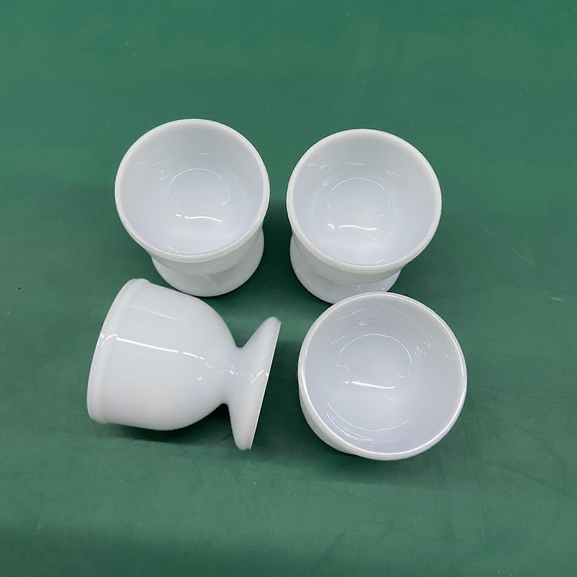 White plastic egg cups, set of 4