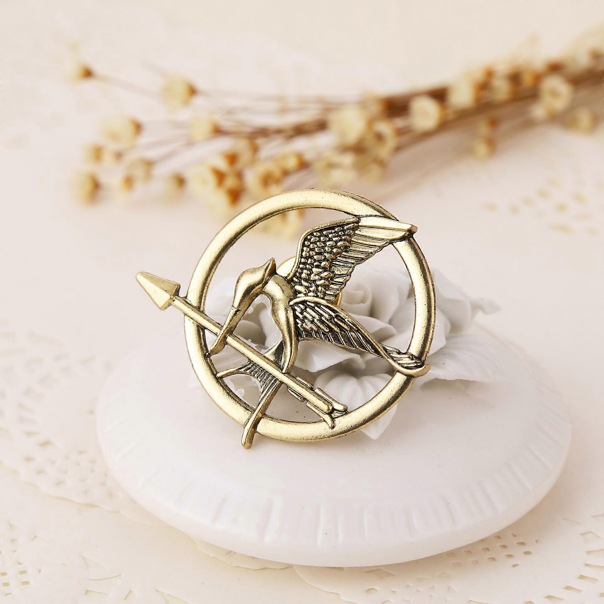 1 role-playing prop representing the Mockingjay pin brooch badge