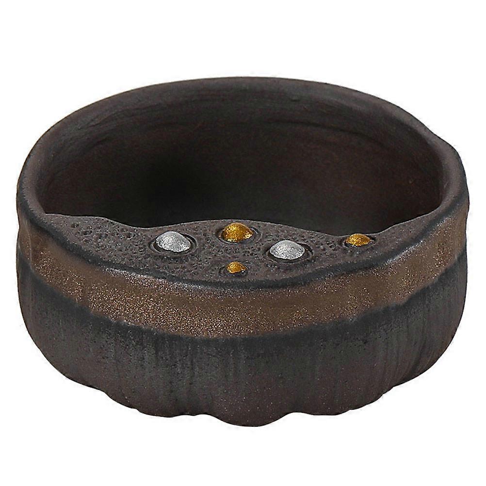 The **Lotus Seedpod Design Ceramic Tea Cup** is a beautifully crafted piece of teaware that combines aesthetic elegance with functional design,