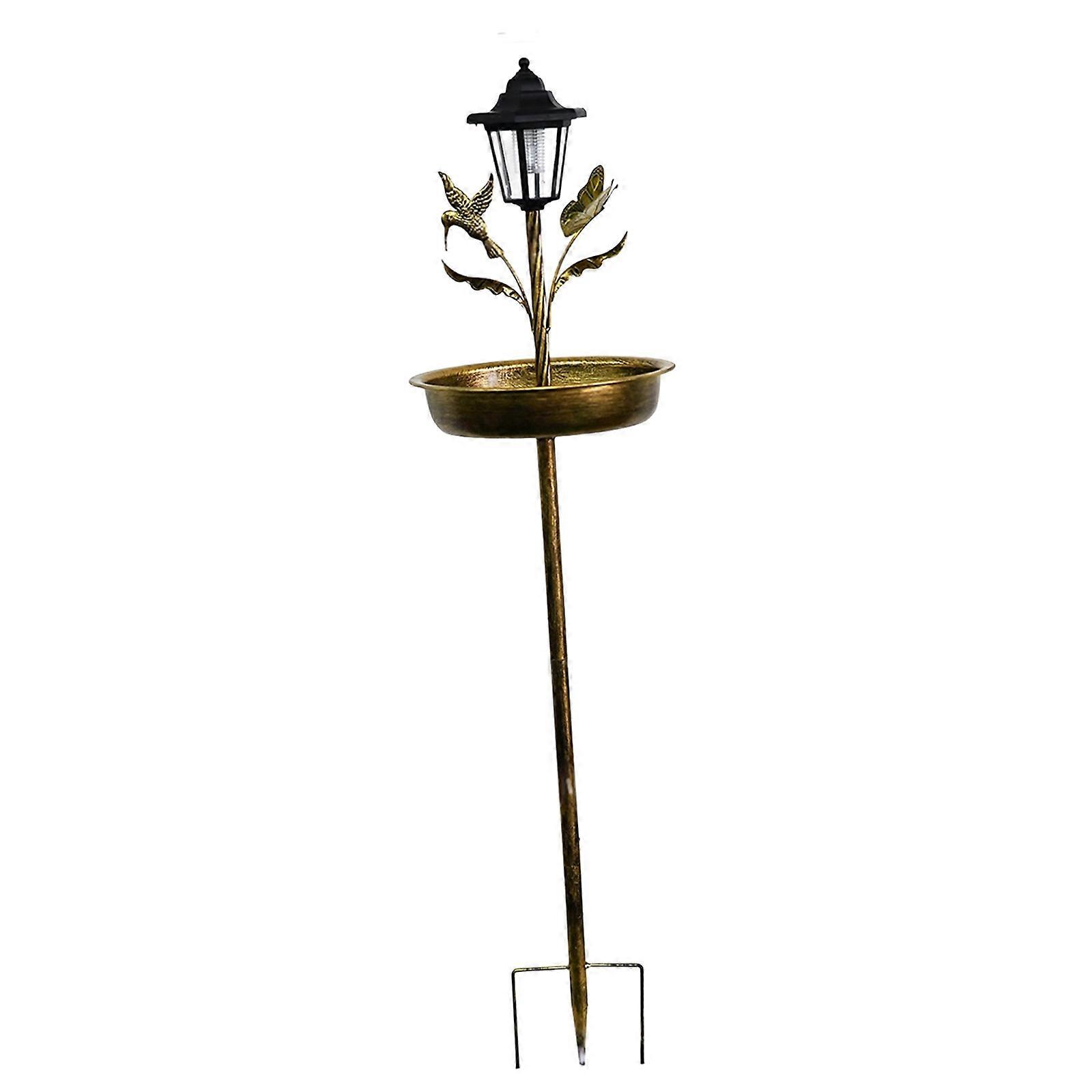 Abreuvoir à oiseaux élégant en métal, éclairé par le soleil, pour embellir votre jardin ou votre pelouse en soirée. Couleur cyan antique.