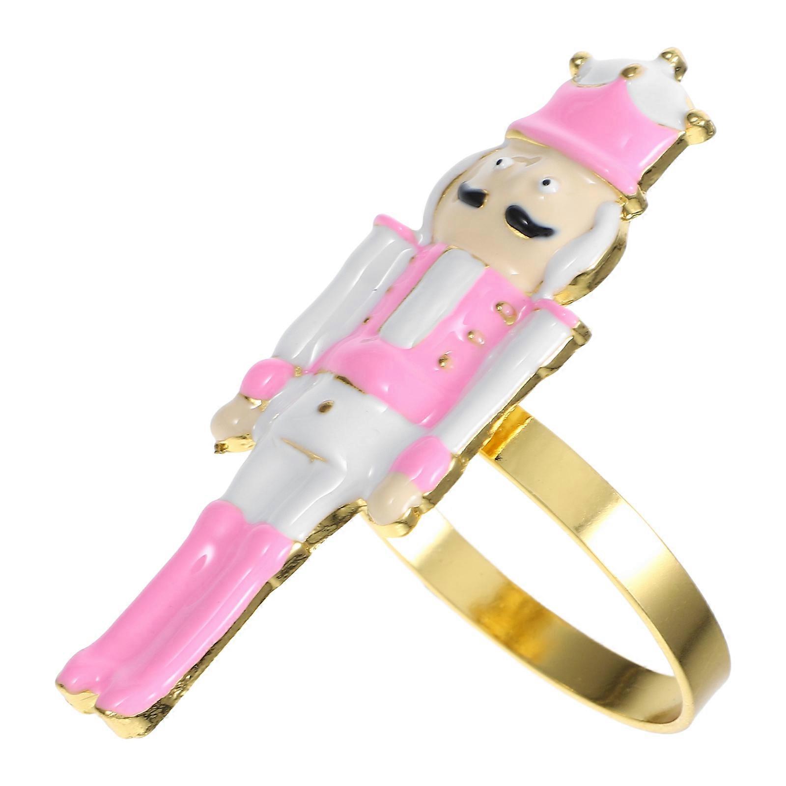 The **Pink and Gold Nutcracker Napkin Ring Metal Holder** is a charming and festive holiday decoration designed to add a touch of whimsy and elegance