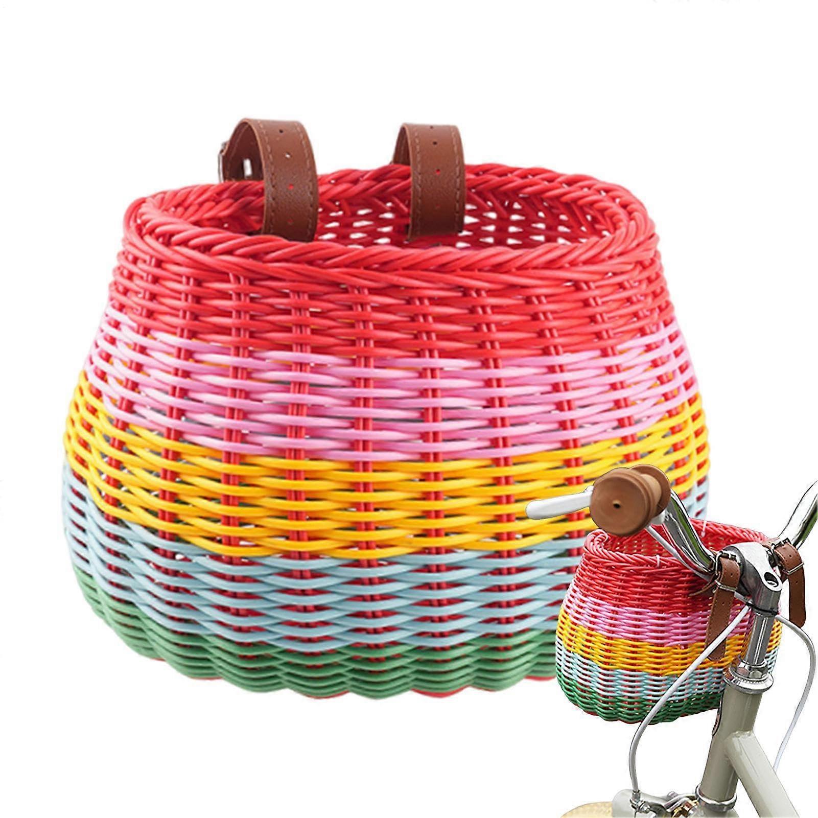 Woven bicycle basket mounted on handlebar with leather straps, removable and robust storage for picnics