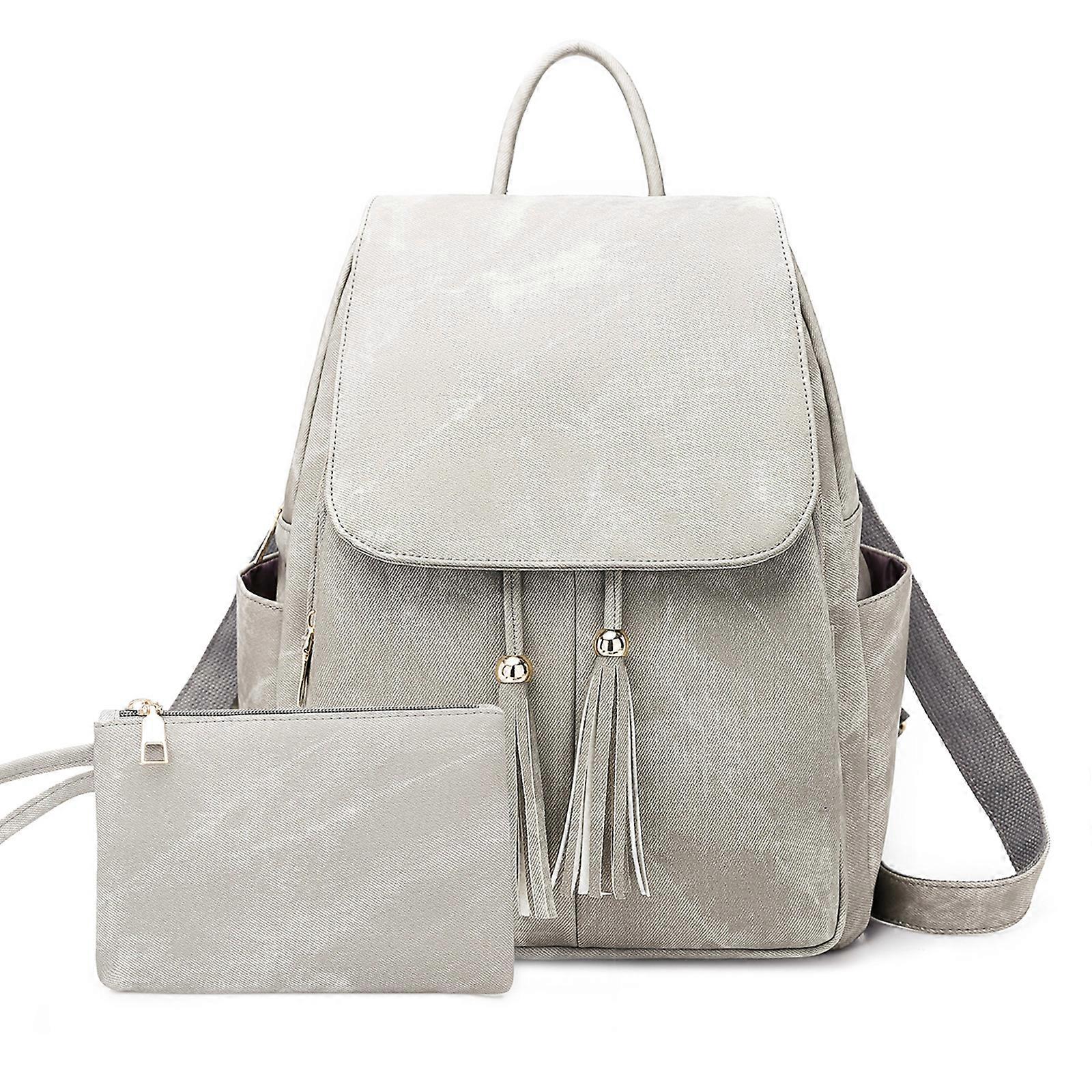 Harmaa reppu karkkisävyillä