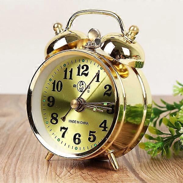 Metal alarm clock, available in gold and silver, manually wound with alarm pause function