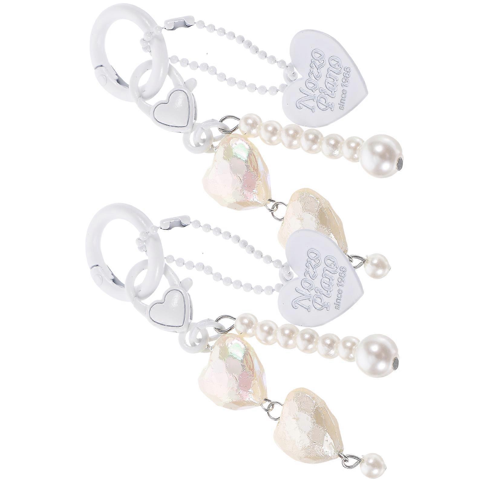 a refined product description based on the details you provided:

 

**2pcs Metal Heart Keychain Cute Love Pendant Bag Charm** 
Add a touch of charm