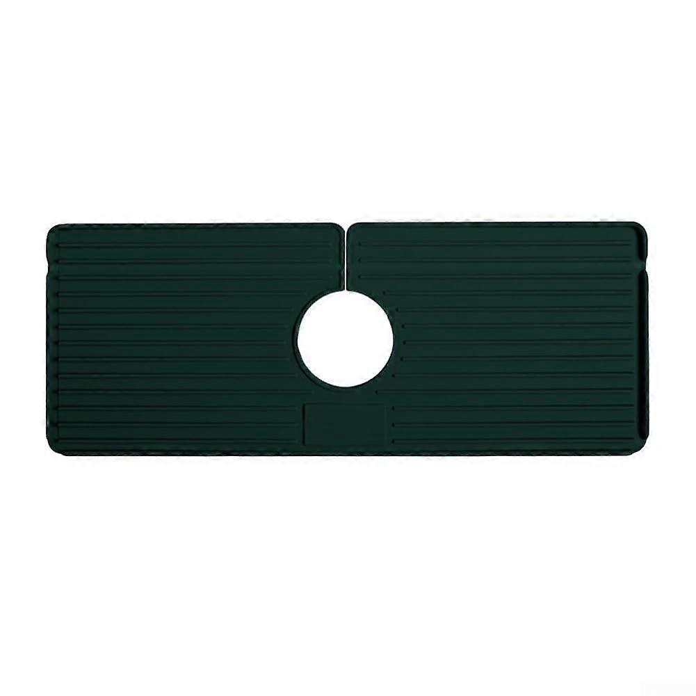 Efficient selfdraining silicone faucet pad reduces water accumulation under faucets (green)