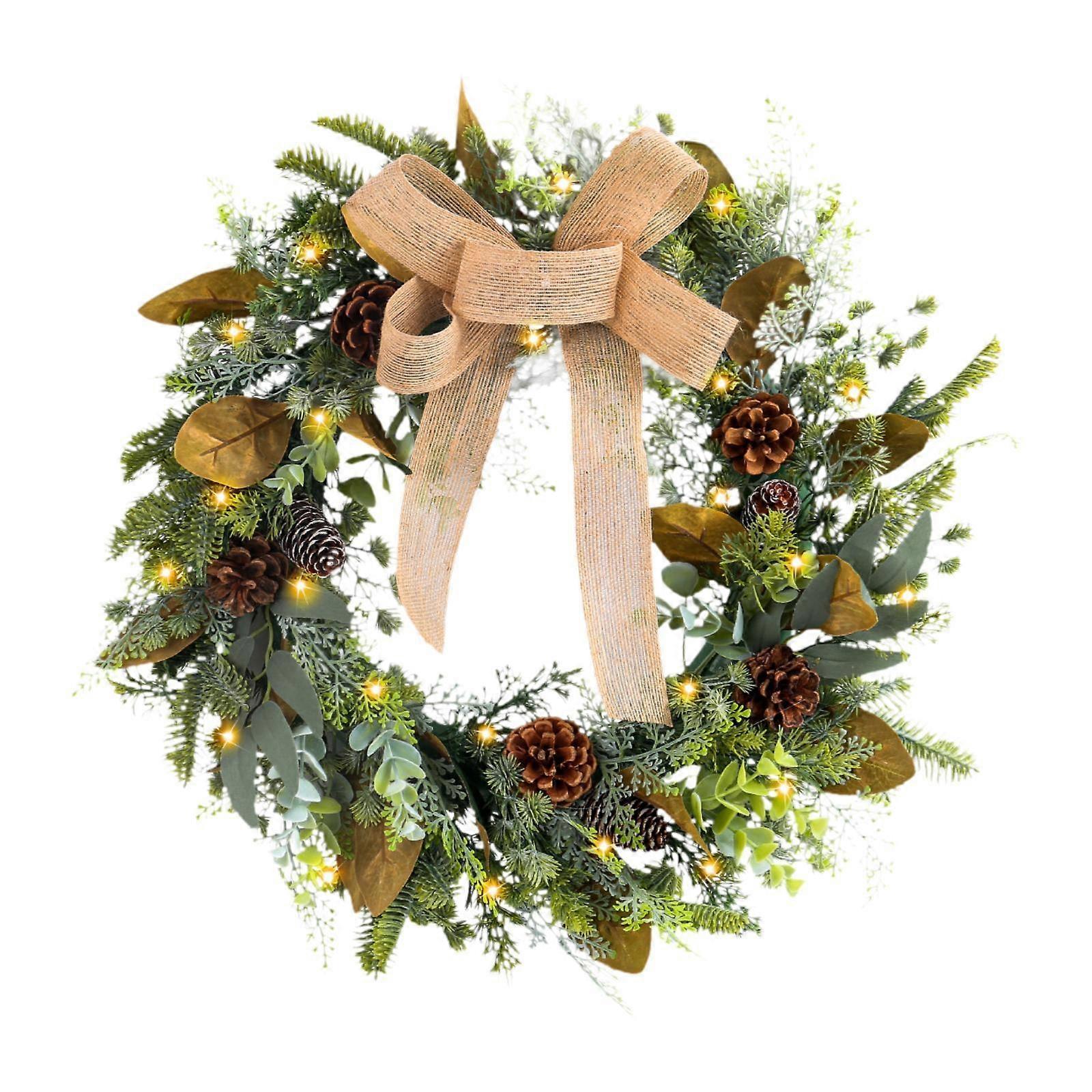 蝶結びのクリスマスデコレーションで飾られたライト付きクリスマスリース