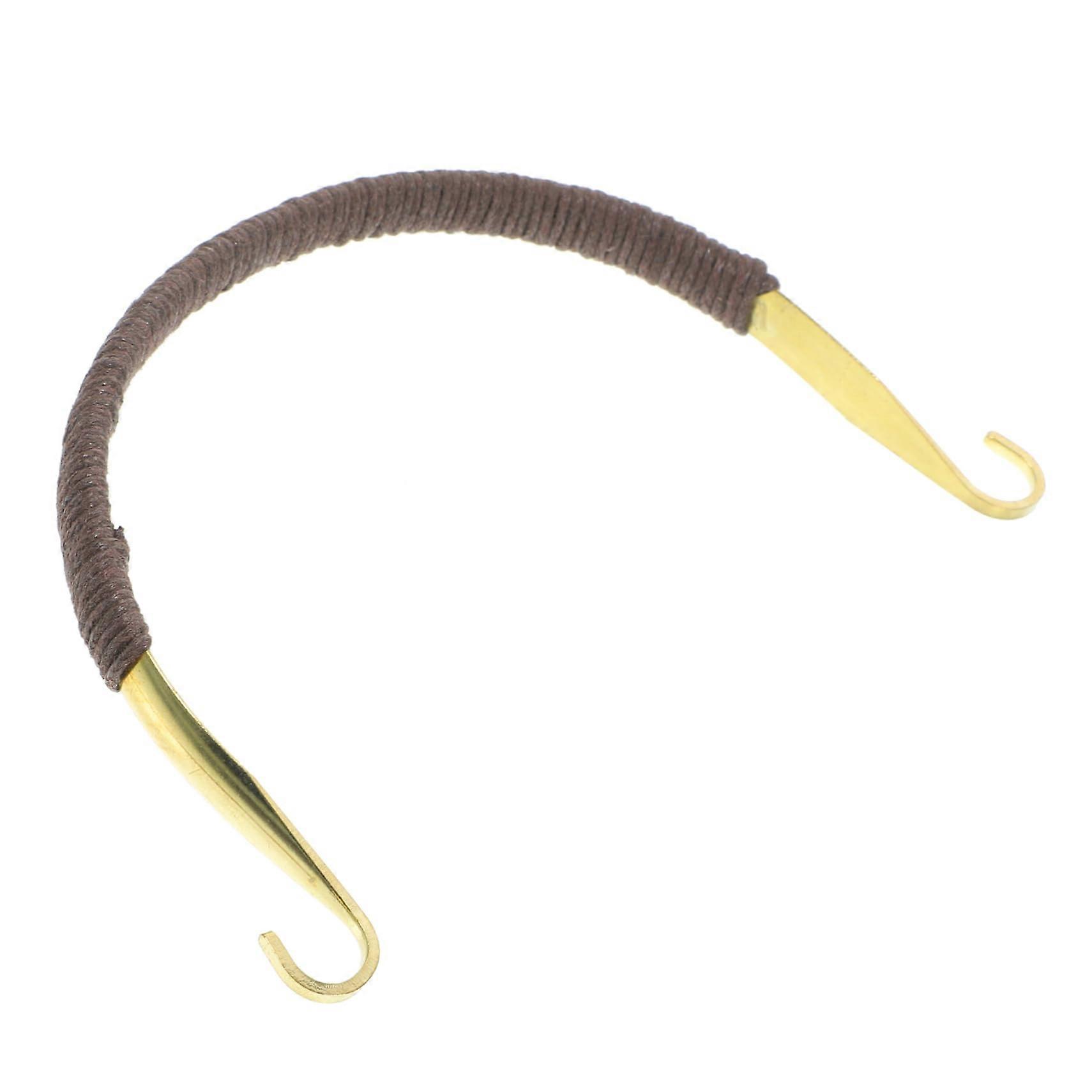 Goldcolored knitted kettle handle alternative for teapots, prevents burns