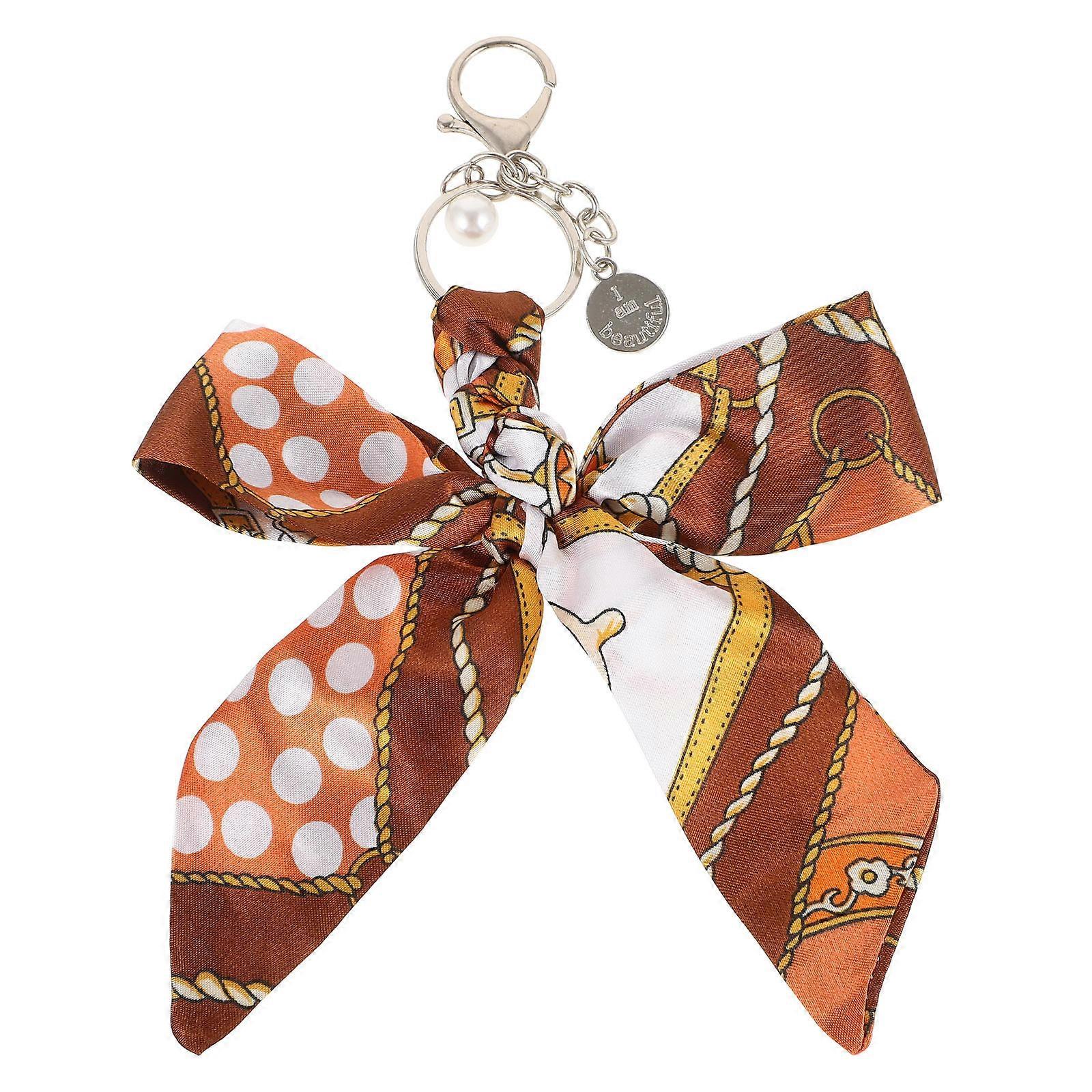 スタイリッシュなハンドバッグのアクセント、鍵や荷物用の生地の弓ペンダント