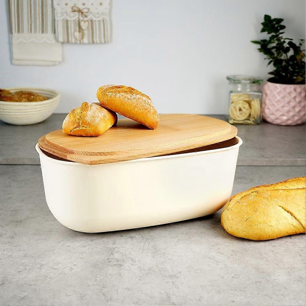 Spacious cream colored bread box with wooden cutting board