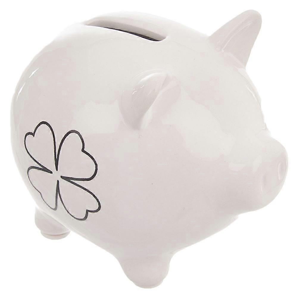 Ceramic piggy bank with clover motif, perfect for saving.
