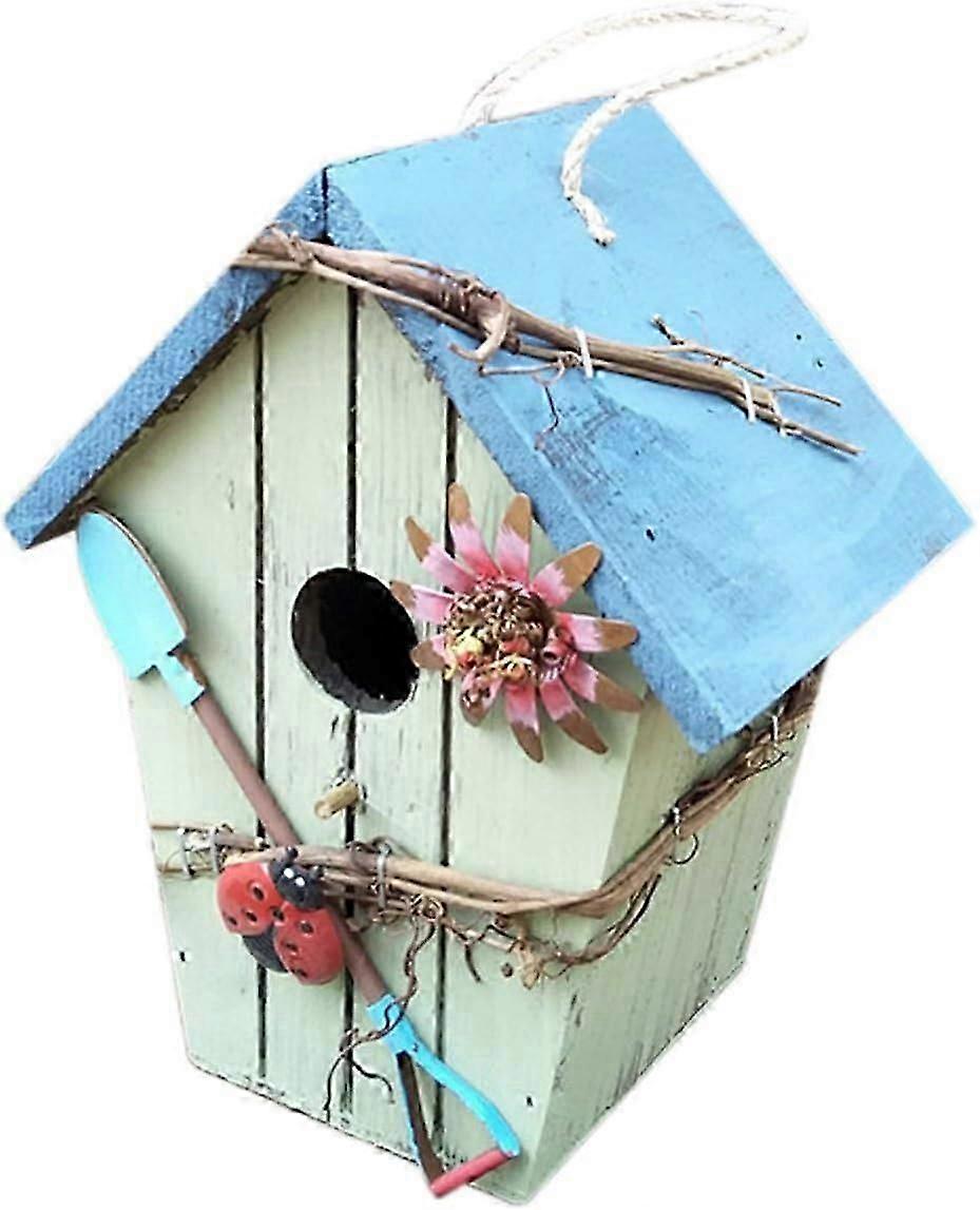 Rustic hanging wooden birdhouse with sloping blue roof
