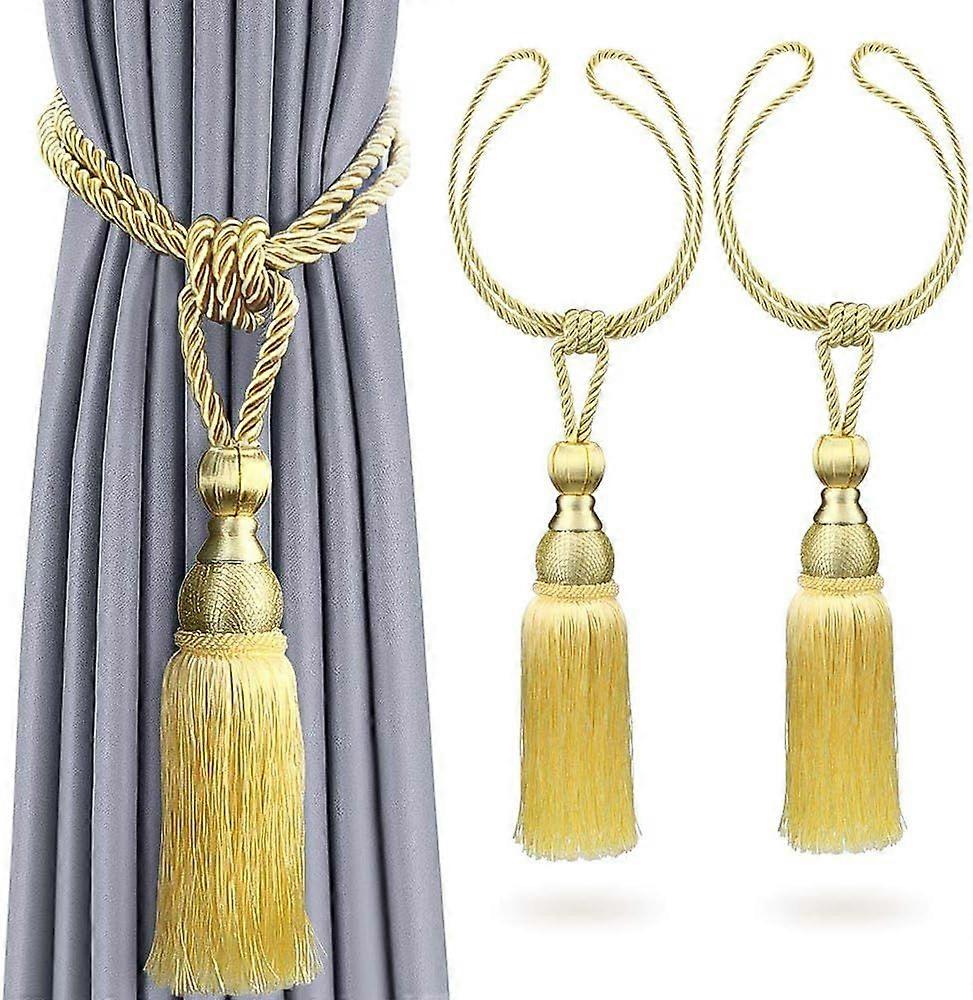 2 curtain tiebacks with fringe, gold color.