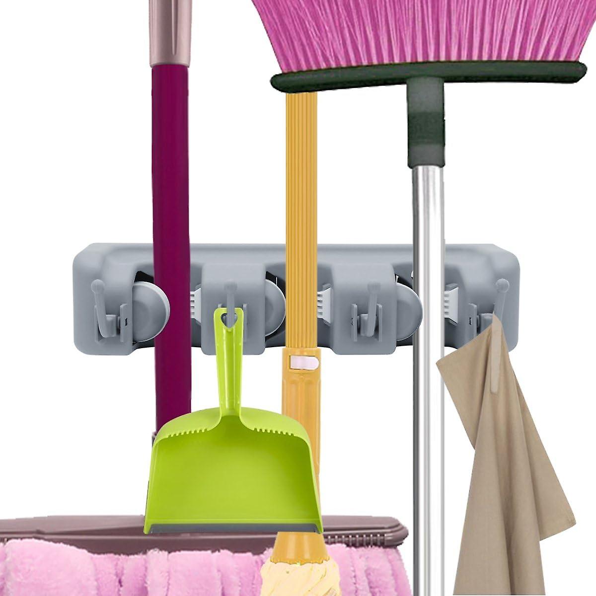 Equipment support wall frame organization with wall frame, broom and garden tool quick release