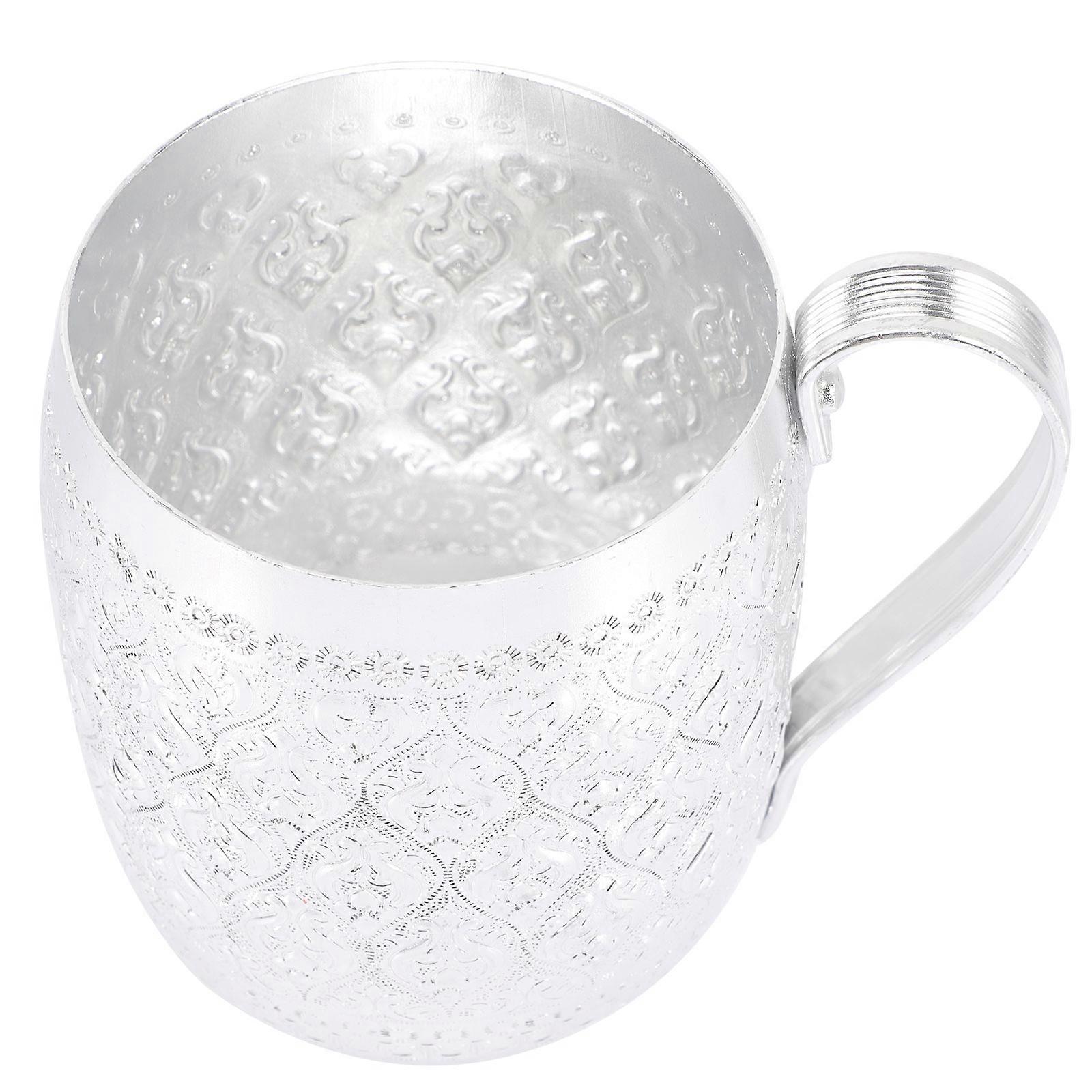 Here's a polished and professional product description based on the details you provided:
**Creative Metal Drinking Mug – Elegant Silver Design