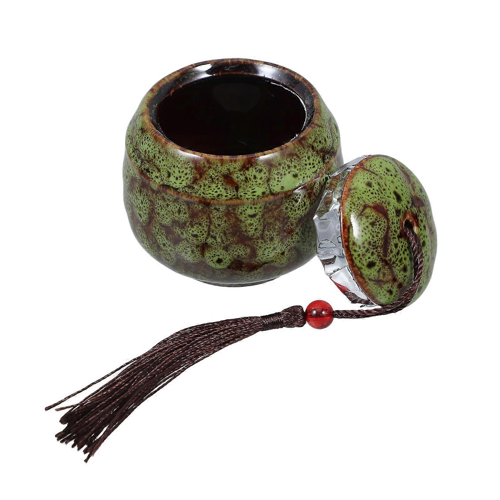 It sounds like you're referring to a **small ceramic pet urn** designed to hold a beloved pet’s ashes. Here's a refined description that could be