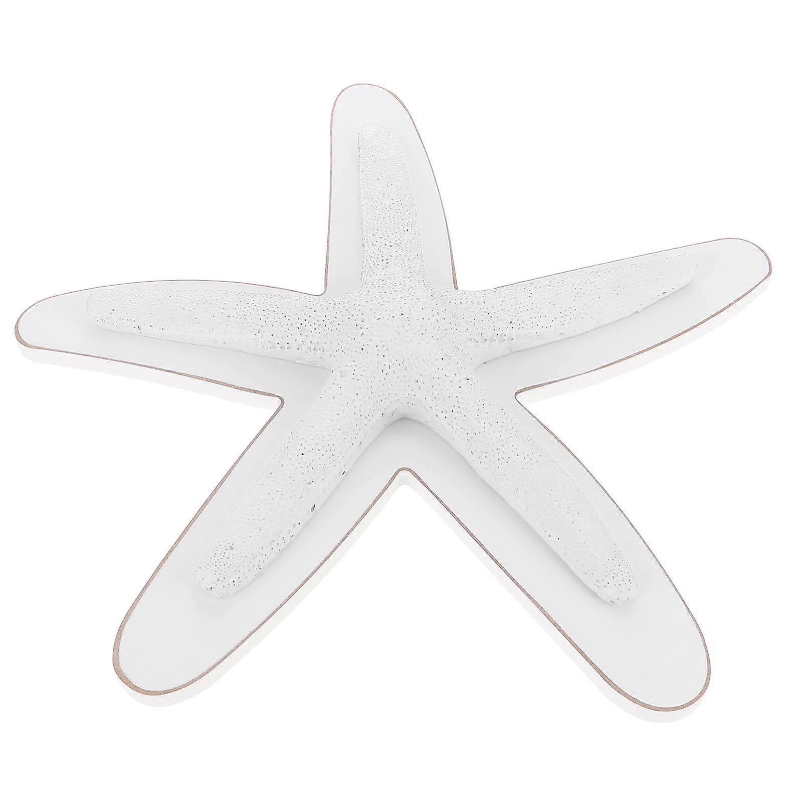 Décoration murale en résine blanche représentant une étoile de mer. Cette étoile de mer décorative est un objet artisanal en résine blanche.