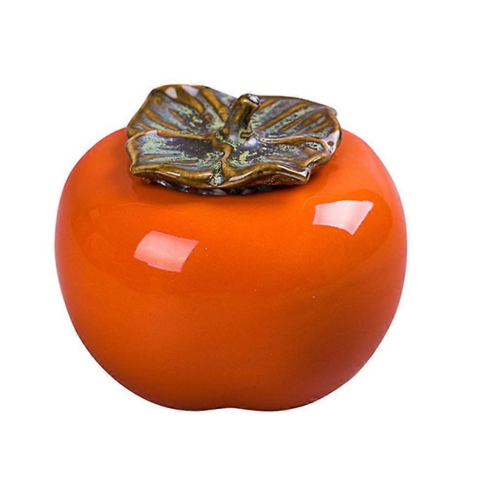 It sounds like you're describing a **ceramic canister** that's shaped like a **persimmon**, designed for **tea storage**, and also doubles as an