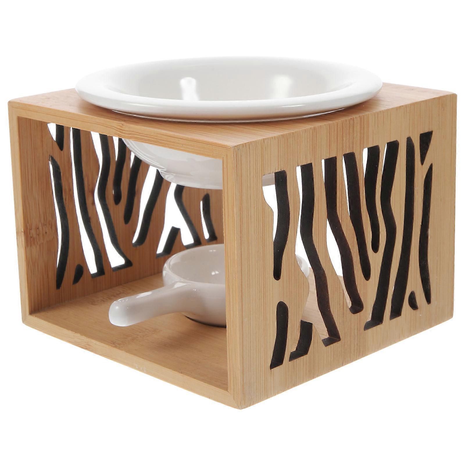 The **Ceramic Tealight Oil Burner** with an **Artistic Bamboo Design** is a stylish and functional aromatherapy accessory designed to enhance the