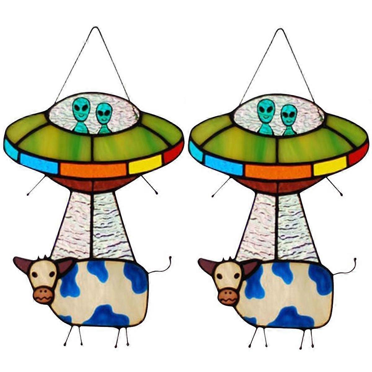 Lot de 2 attrape-soleil en verre teinté représentant une vache et un OVNI