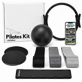Home Pilates set with elastic resistance bands, hoop, ball, and gliding discs.
