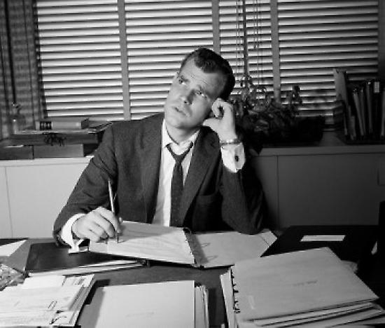 Businessman working at desk Poster