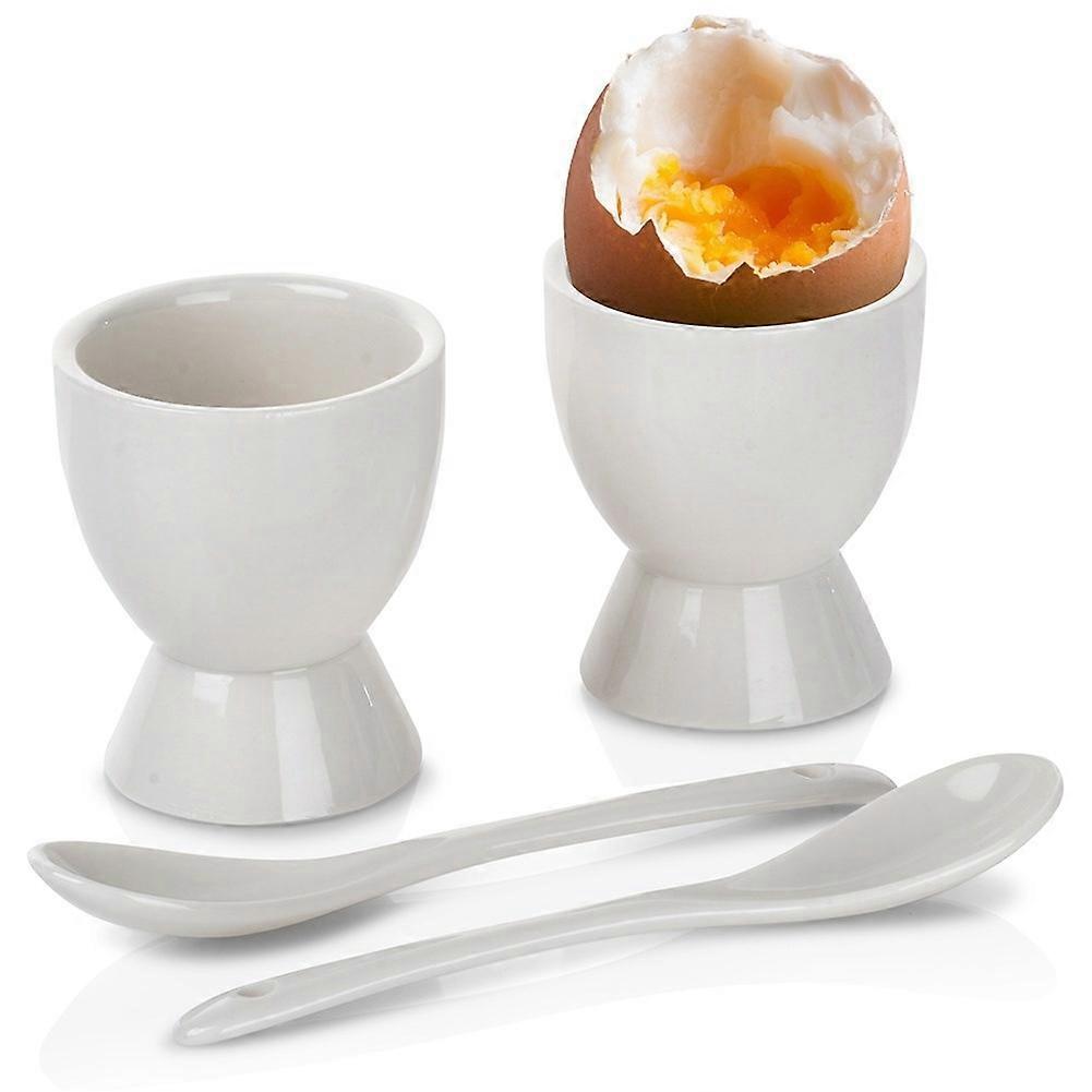Set of two white porcelain egg cups with spoons