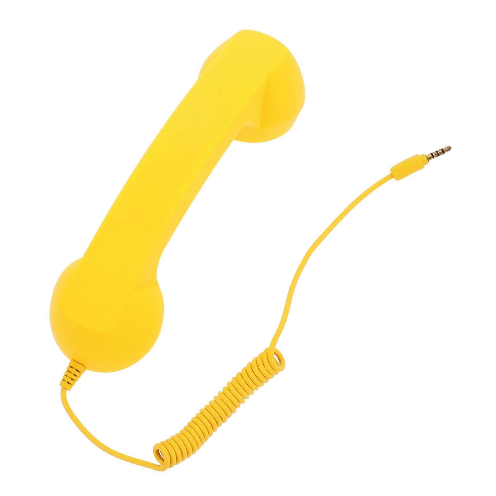 Plastic universal telephone in retro style, yellow material for calls.