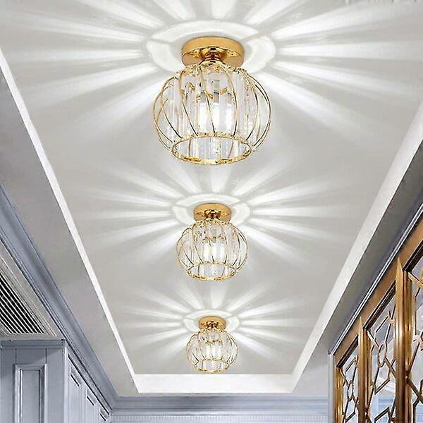 Mini crystal chandelier with E27 light source and triangular crystal refracting light