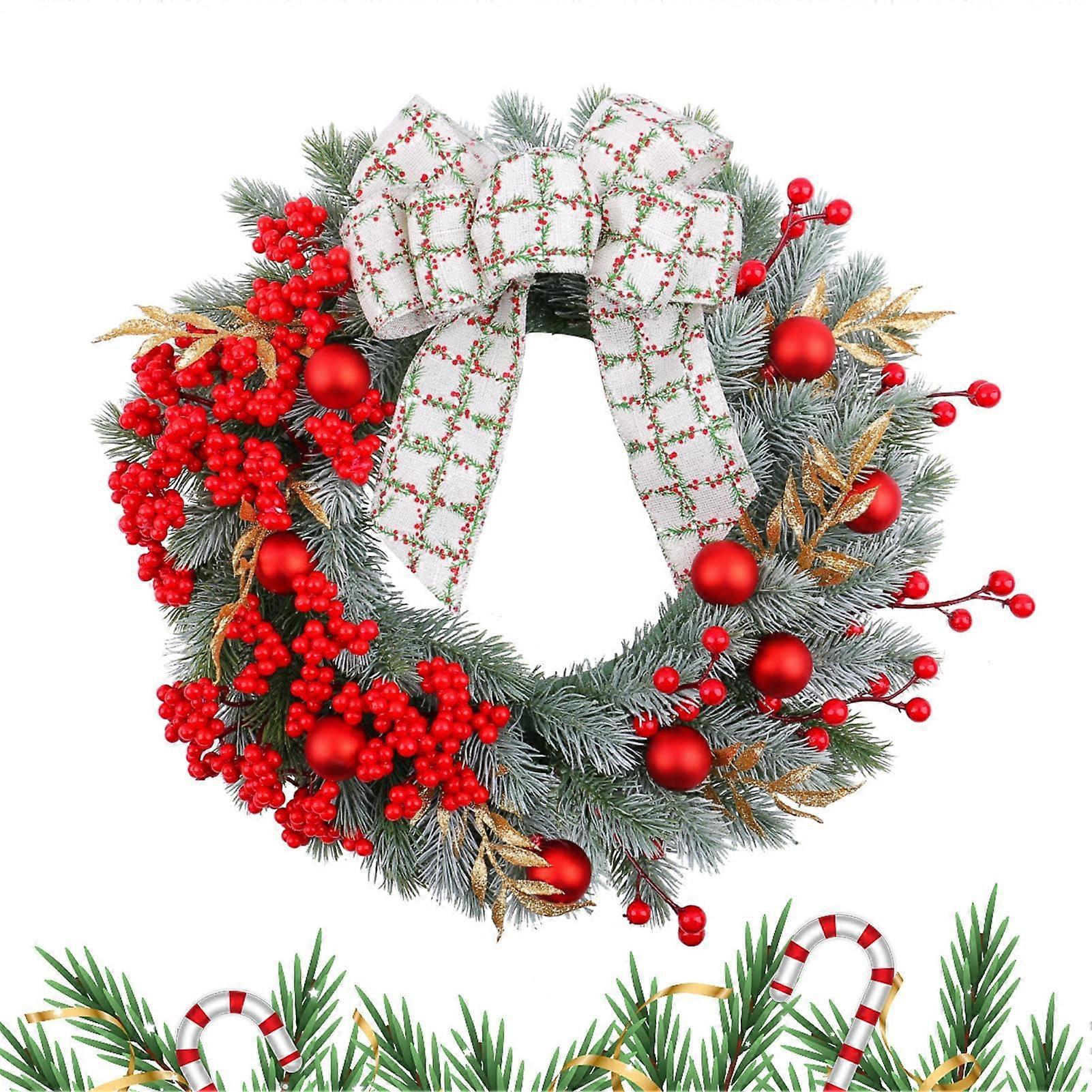 Christmas wreath with bow, berries and garland for the front door