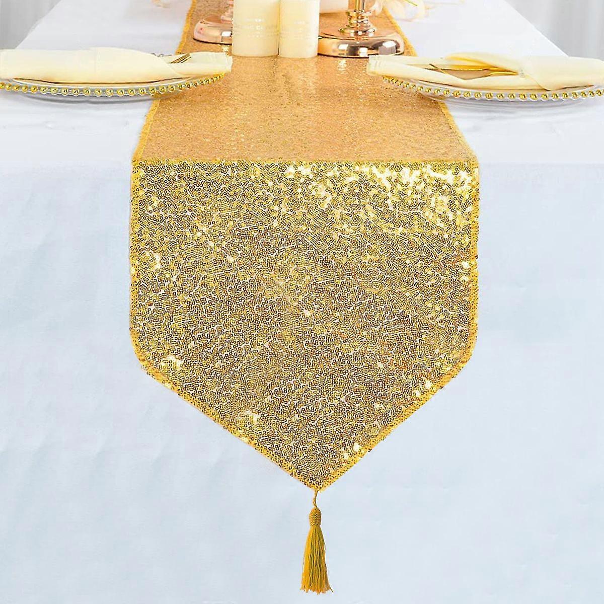 Gold keyed table runner with tassels and sequins