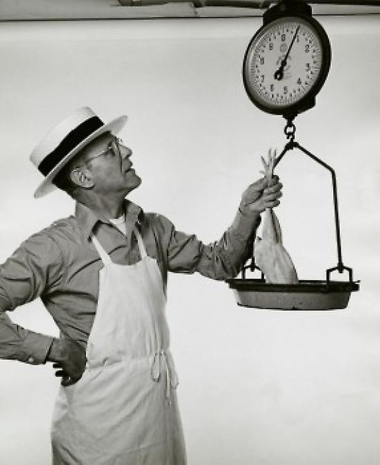 Butcher weighing a chicken Poster
