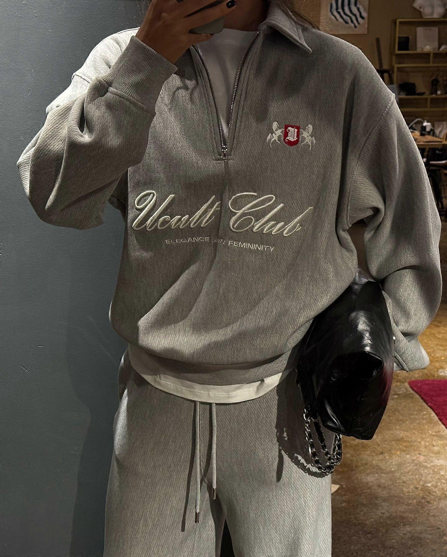 Grey Half-Zip Sweatshirt with Embroidered Logo and Red Shield Patch