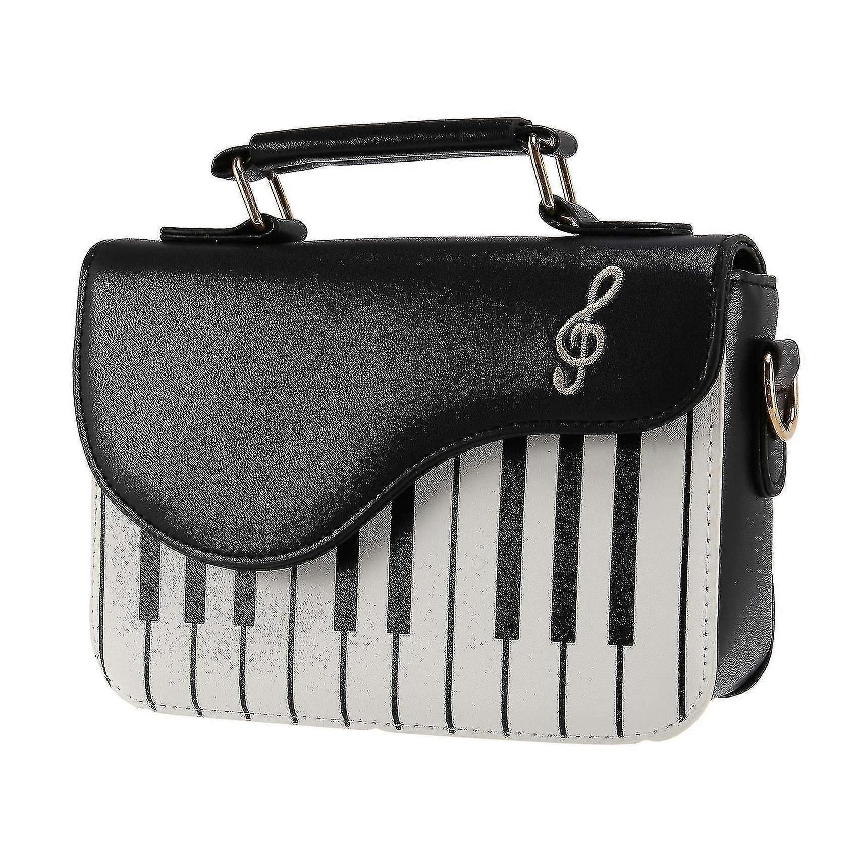 Small portable bag with piano print in black and shoulder strap.