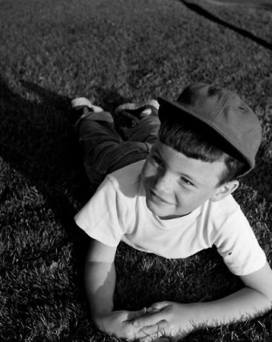Boy lying on lawn Poster