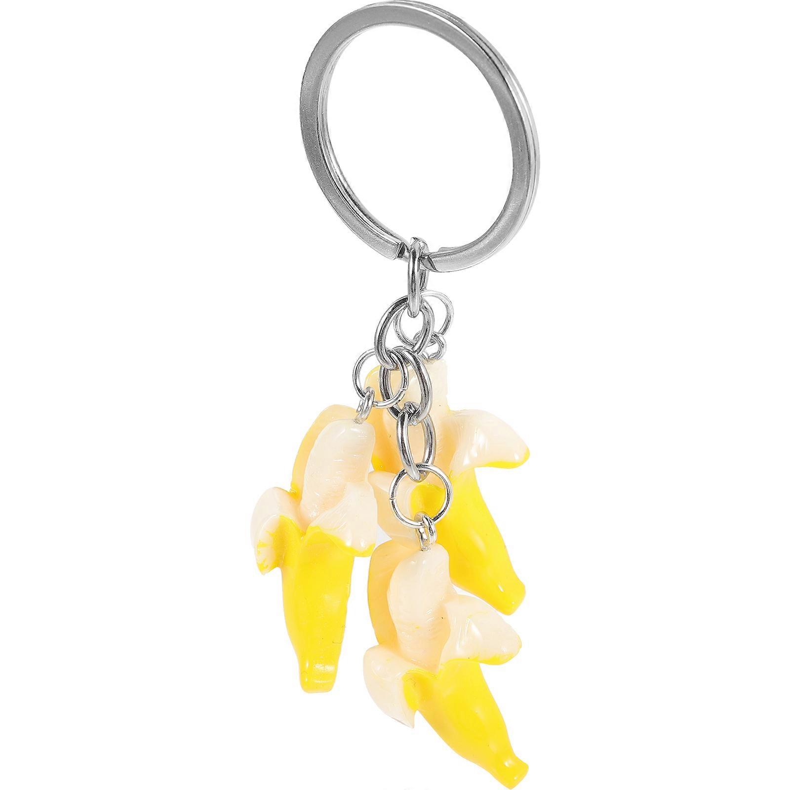 It sounds like you're describing a **kawaii banana keychain pendant** — a cute and fun accessory that's often used as a decorative charm for:

 Car