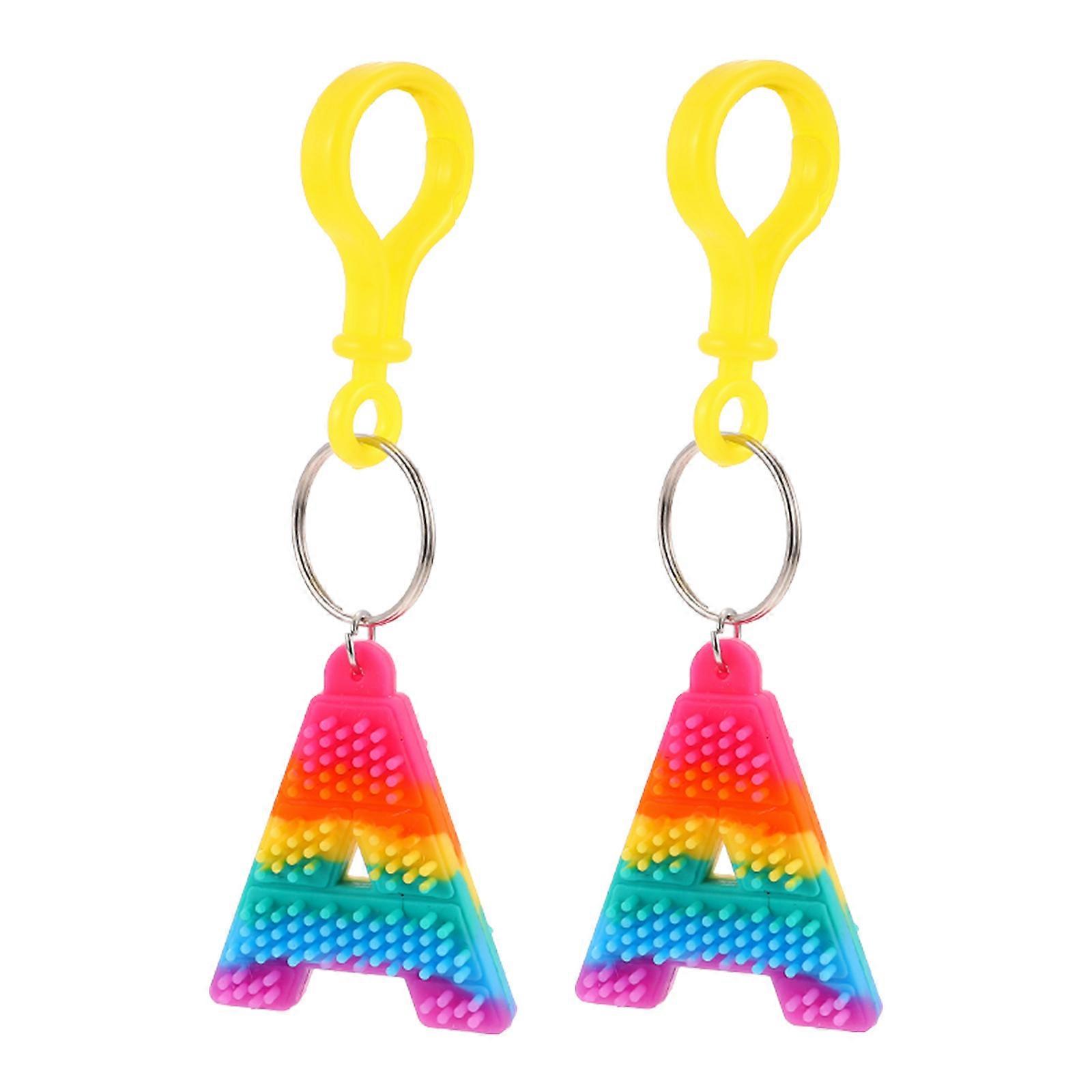 It seems like you're referring to a product listing or description for **"2pcs Alphabet Key Chains Decompression Bag Pendants For Car Decor Stylish