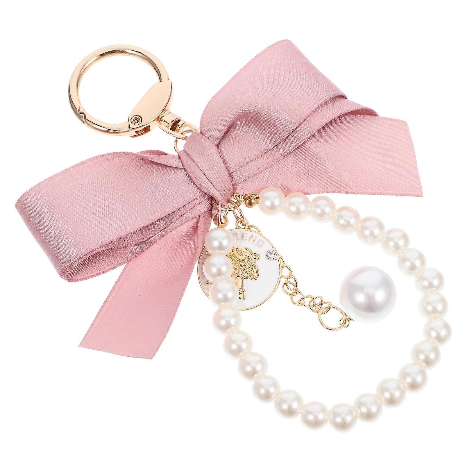 Here's a refined and appealing product description based on the title you provided:
**Elegant Vintage Bow Pearl Keychain – Stylish Bowknot Design